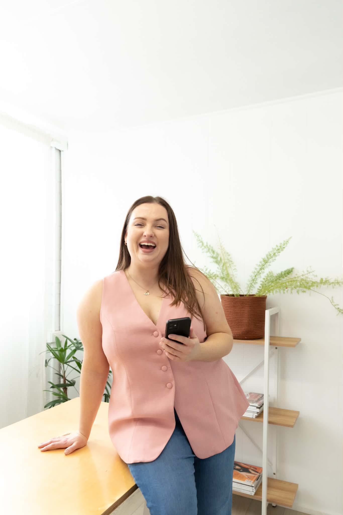 Monique, founder of Bold Type Marketing, laughing while working